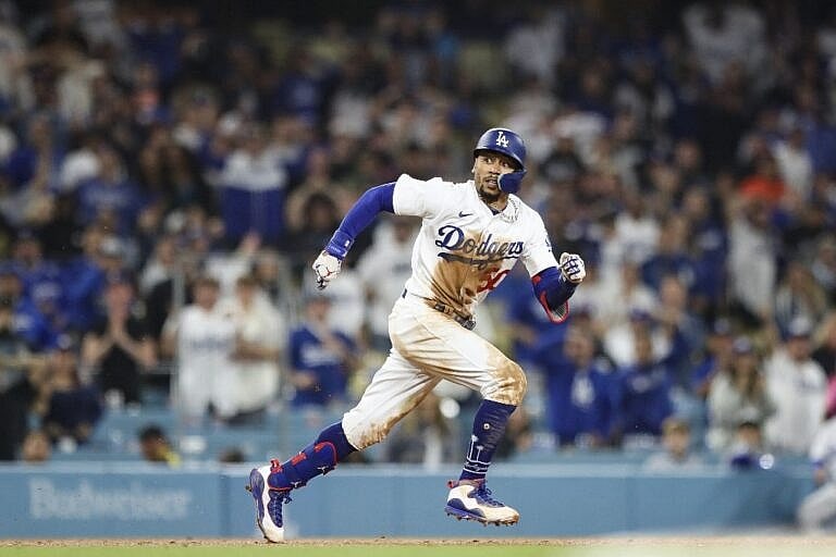 Mookie Betts #50 of the Los Angeles Dodgers gets caught between second and third base in the eleventh inning against the San Francisco Giants