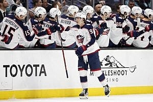 Kent Johnson #91 of the Columbus Blue Jackets celebrates his goal with teammates against the Seattle Kraken.