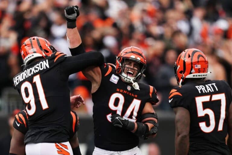 Trey Hendrickson #91 and Sam Hubbard #94 of the Cincinnati Bengals celebrate with teammates after a sack during the game against the Seattle Seahawks.
