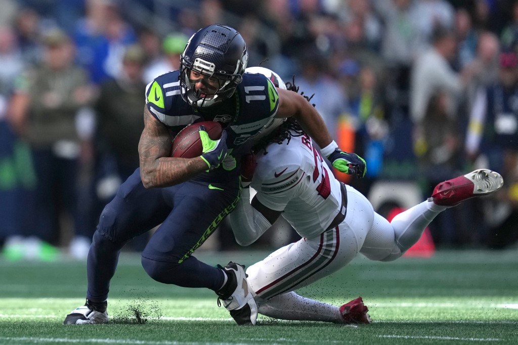 The cover for this NFL player props week 12 article shows Jaxon Smith-Njigba #11 of the Seattle Seahawks being tackled by Denzel Burke #29 of the Arizona Cardinals