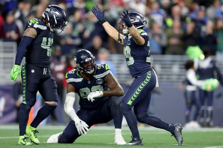 Drake Thomas #42, Leonard Williams #99 and Ty Okada #39 of the Seattle Seahawks react against the Houston Texans.