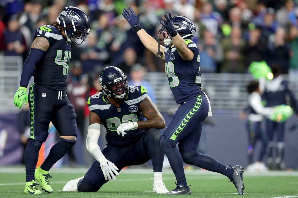 Drake Thomas #42, Leonard Williams #99 and Ty Okada #39 of the Seattle Seahawks react against the Houston Texans.