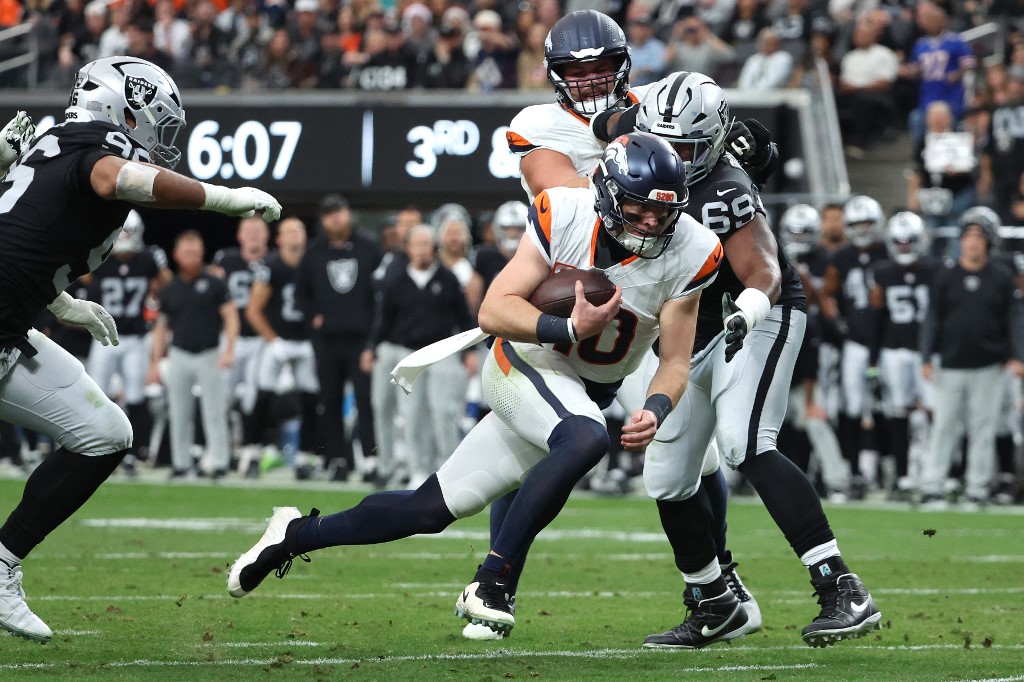 The cover for this NFL player props week 15 article shows Bo Nix #10 of the Denver Broncos rushing for a touchdown against the Las Vegas Raiders.