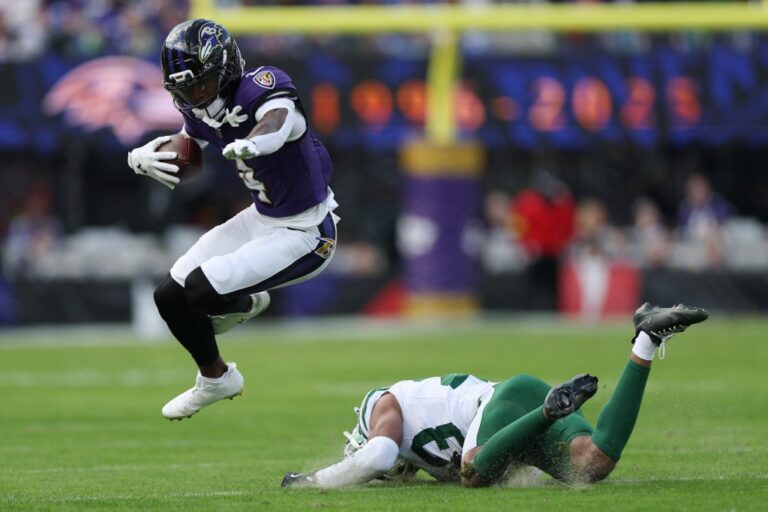 The cover for this NFL player props article shows Zay Flowers #4 of the Baltimore Ravens evades a tackle against Azareye'h Thomas #23 of the New York Jets.