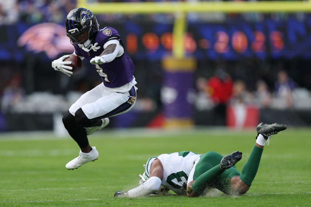 The cover for this NFL player props article shows Zay Flowers #4 of the Baltimore Ravens evades a tackle against Azareye'h Thomas #23 of the New York Jets.