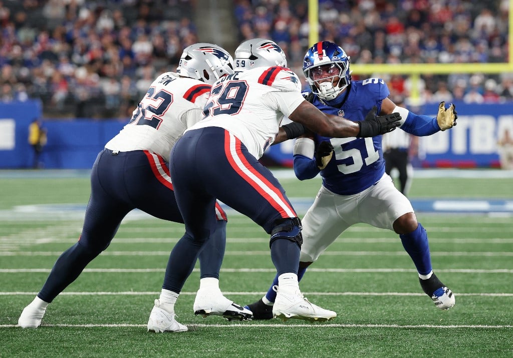 Abdul Carter #51 of the New York Giants in action against Cole Strange #69 and Sidy Sow #62 of the New England Patriots