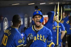 Julio Rodriguez #44 of the Seattle Mariners celebrates with Victor Robles #10 after hitting a three-run home run during the eighth inning against the Texas Rangers.