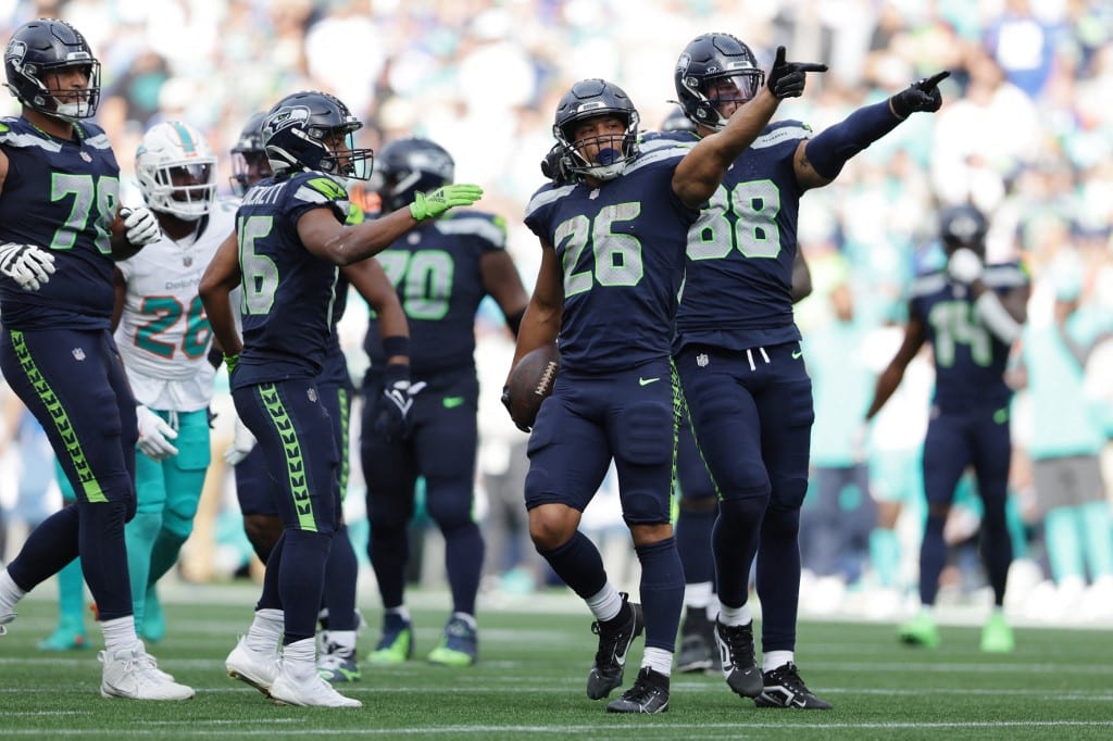 Zach Charbonnet #26 of the Seattle Seahawks celebrates with teammates during a game against the Miami Dolphins