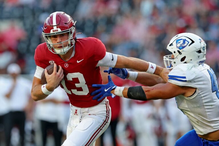 Eastern Illinois v Alabama - Oddstrader - Oddstrader The cover for this College football picks week 14 article shows John Gazzaniga #13 of the Alabama Crimson Tide giving a stiff arm to Jesse Garza #49 of the Eastern Illinois Panthers.