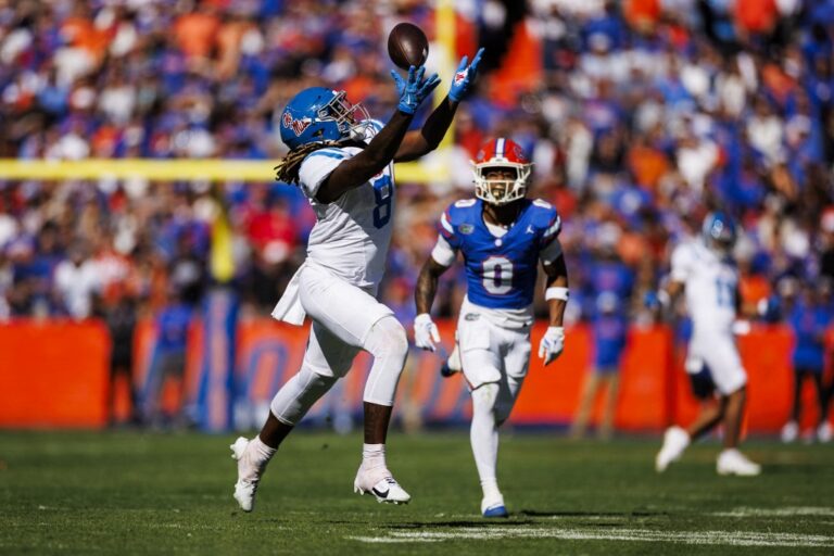 Ole Miss v Florida - Oddstrader - Oddstrader Dae'Quan Wright of the Mississippi Rebels attempts to catch a pass against the Florida Gators, a matchup featured in our College football picks week 12.