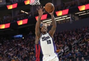DeMar DeRozan #10 of the Sacramento Kings shoots over Draymond Green #23 of the Golden State Warriors.