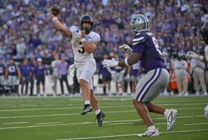 Quarterback Cale Hellums #3 of the Army Black Knights throws a pass against defensive end Chiddi Obiazor #8 of the Kansas State Wildcats
