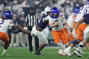 Maddux Madsen #4 of the Boise State Broncos is pressure by Abdul Carter #11 of the Penn State Nittany Lions