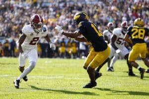 Aamir Hall #12 of the Michigan Wolverines defends Ryan Williams #2 of the Alabama Crimson Tide.