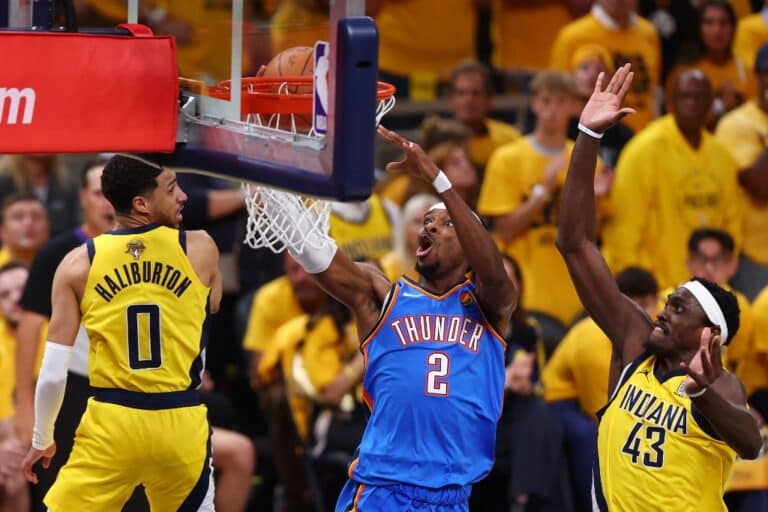 Shai Gilgeous-Alexander #2 of the Oklahoma City Thunder attempts a layup against Pascal Siakam #43 of the Indiana Pacers
