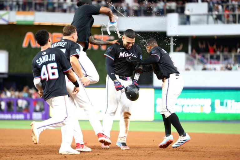 Agustín Ramírez #50 of the Miami Marlins celebrates with teammates after walking it off to defeat the New York Yankees.
