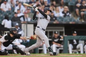 Cody Bellinger #35 of the New York Yankees hits a two-run home run against the Chicago White Sox.