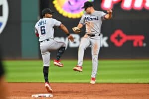 Otto Lopez and Jakob Marsee of the Miami Marlins celebrate after defeating the Cleveland Guardians.