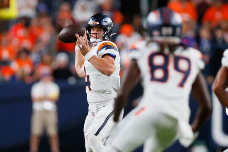 Sam Ehlinger #4 of the Denver Broncos throws a pass to Courtney Jackson #89.