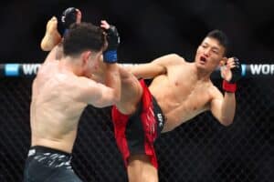 Sumudaerji of China kicks Mitch Raposo in a flyweight bout during UFC 314.