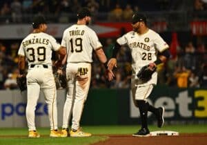 Tommy Pham of the Pittsburgh Pirates celebrates with Jared Triolo and Nick Gonzales after the win over the Colorado Rockies.