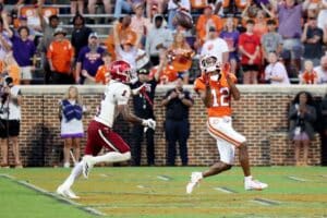 Bryant Wesco Jr. #12 of the Clemson Tigers scores touchdown in the fourth quarter as Kaleno Levine #5 of the Troy Trojans defends
