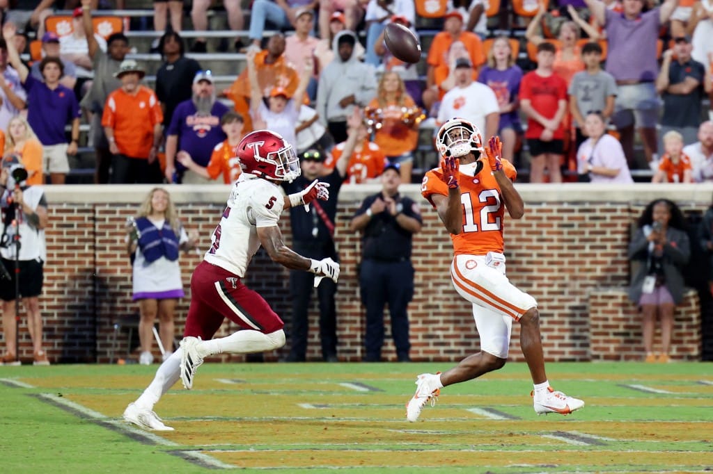 Bryant Wesco Jr. #12 of the Clemson Tigers scores touchdown in the fourth quarter as Kaleno Levine #5 of the Troy Trojans defends
