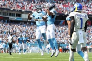 Cam Ward #1 of the Tennessee Titans celebrates a touchdown pass with Elic Ayomanor #5 against the Los Angeles Rams