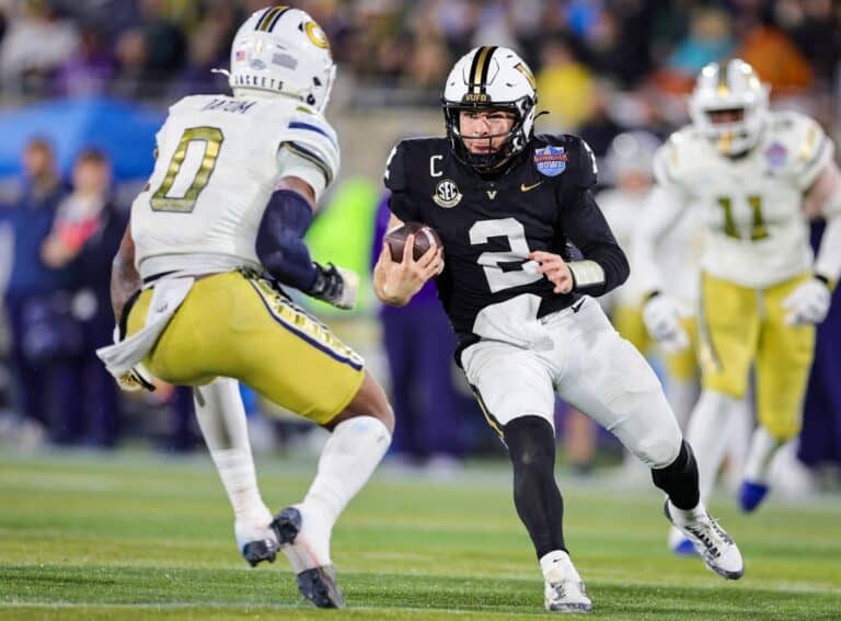 Diego Pavia #2 of the Vanderbilt Commodores runs the ball at Trenilyas Tatum #0 of the Georgia Tech Yellow Jackets