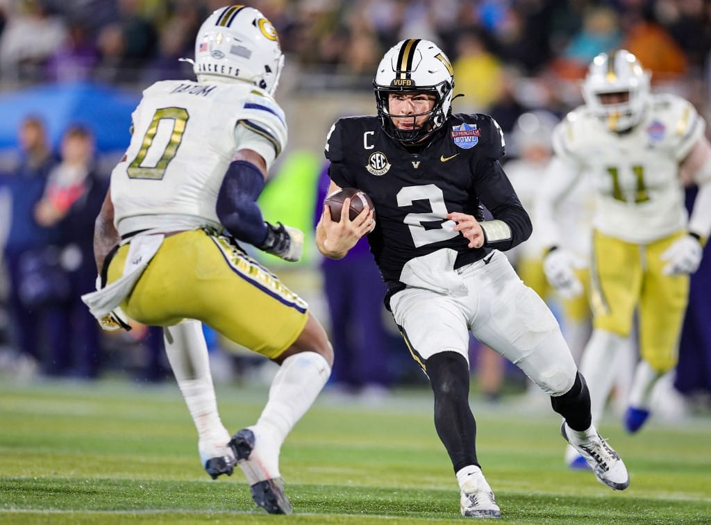 Diego Pavia #2 of the Vanderbilt Commodores runs the ball at Trenilyas Tatum #0 of the Georgia Tech Yellow Jackets
