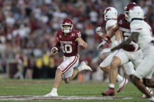 Quarterback John Mateer #10 of the Oklahoma Sooners slows his run as he rolls out against Illinois State Redbirds