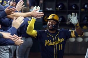 Jackson Chourio #11 of the Milwaukee Brewers is congratulated in the dugout after hitting a solo home run against the Texas Rangers