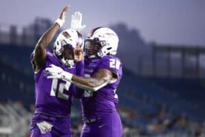 JC Evans #12 of the James Madison Dukes celebrates his touchdown with Jobi Malary #28 against the Western Kentucky Hilltoppers
