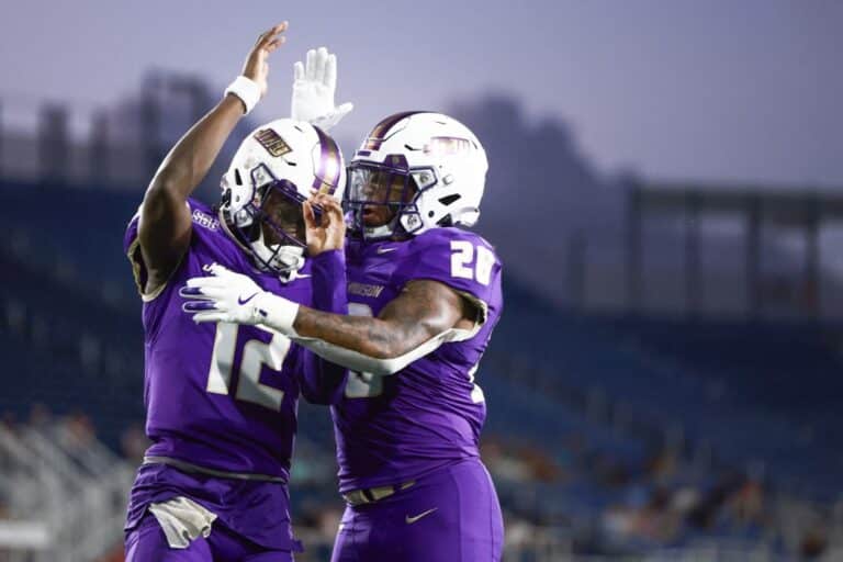 JC Evans #12 of the James Madison Dukes celebrates his touchdown with Jobi Malary #28 against the Western Kentucky Hilltoppers