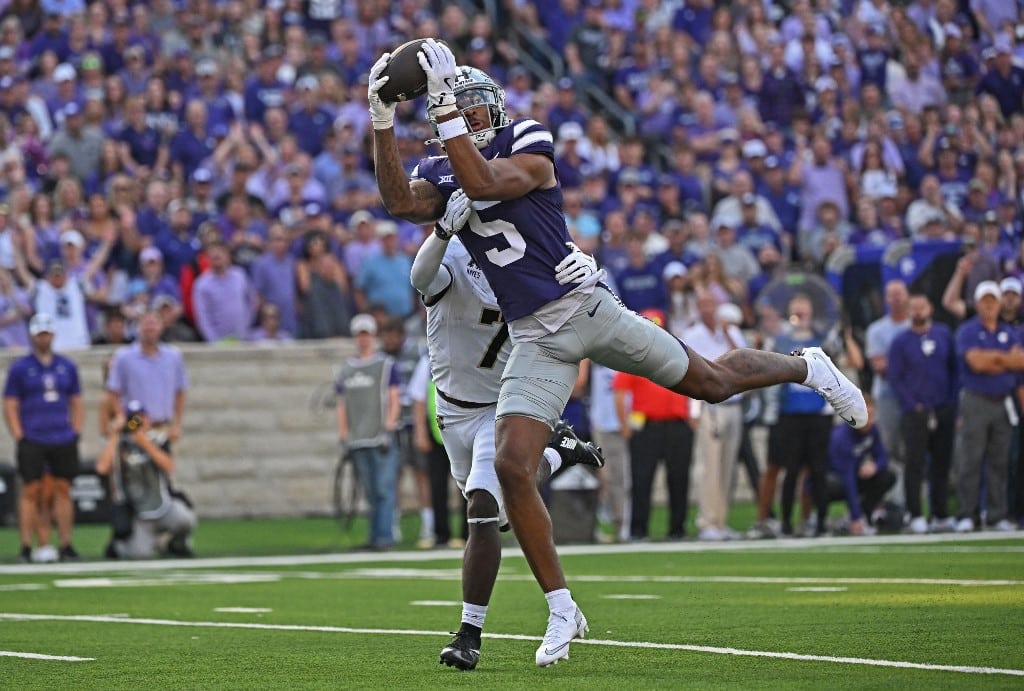 Wide receiver Jerand Bradley #5 of the Kansas State Wildcats goes up for the ball against cornerback Jaydan Mayes #7 of the Army Black Knights.