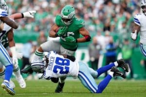 Malik Hooker #28 of the Dallas Cowboys tackles Saquon Barkley #26 of the Philadelphia Eagles.