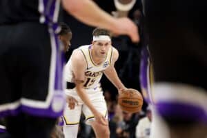 Austin Reaves #15 of the Los Angeles Lakers dribbles the ball against the Sacramento Kings