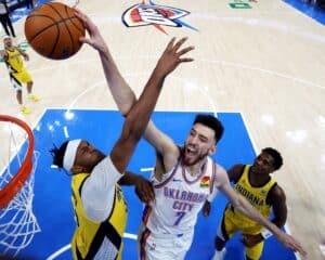 Chet Holmgren #7 of the Oklahoma City Thunder attempts a dunk against Myles Turner #33 of the Indiana Pacers
