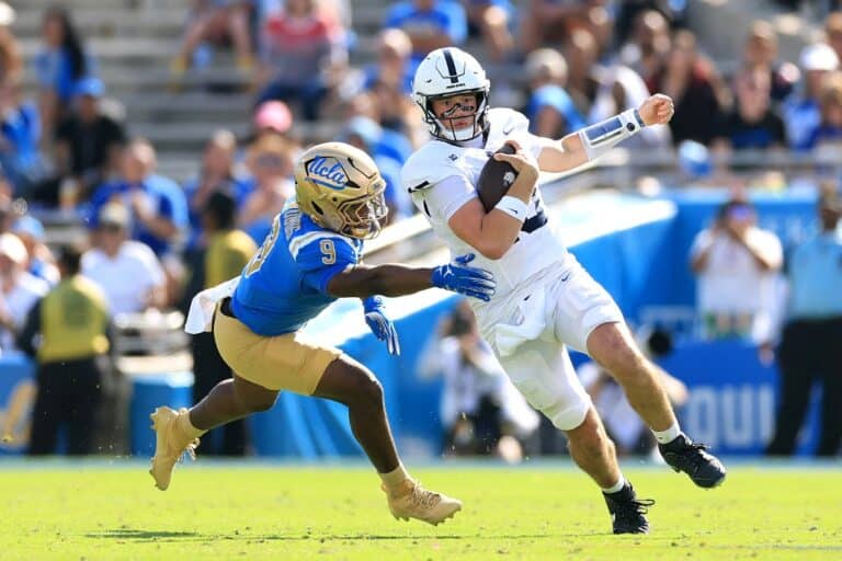 Drew Allar #15 of the Penn State Nittany Lions runs the ball against Jalen Woods #9 of the UCLA Bruins