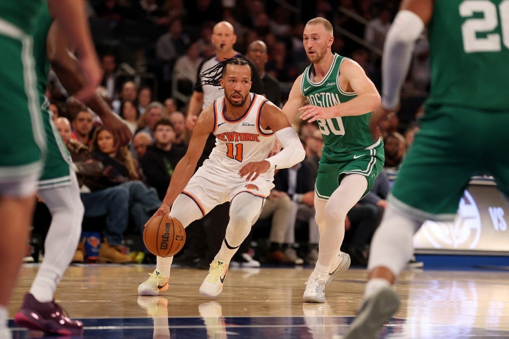 Jalen Brunson #11 of the New York Knicks drives against Sam Hauser #30 of the Boston Celtics