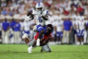 Javon Robinson #5 of the Georgia State Panthers carries the ball against TJ Dottery #6 of the Mississippi Rebels