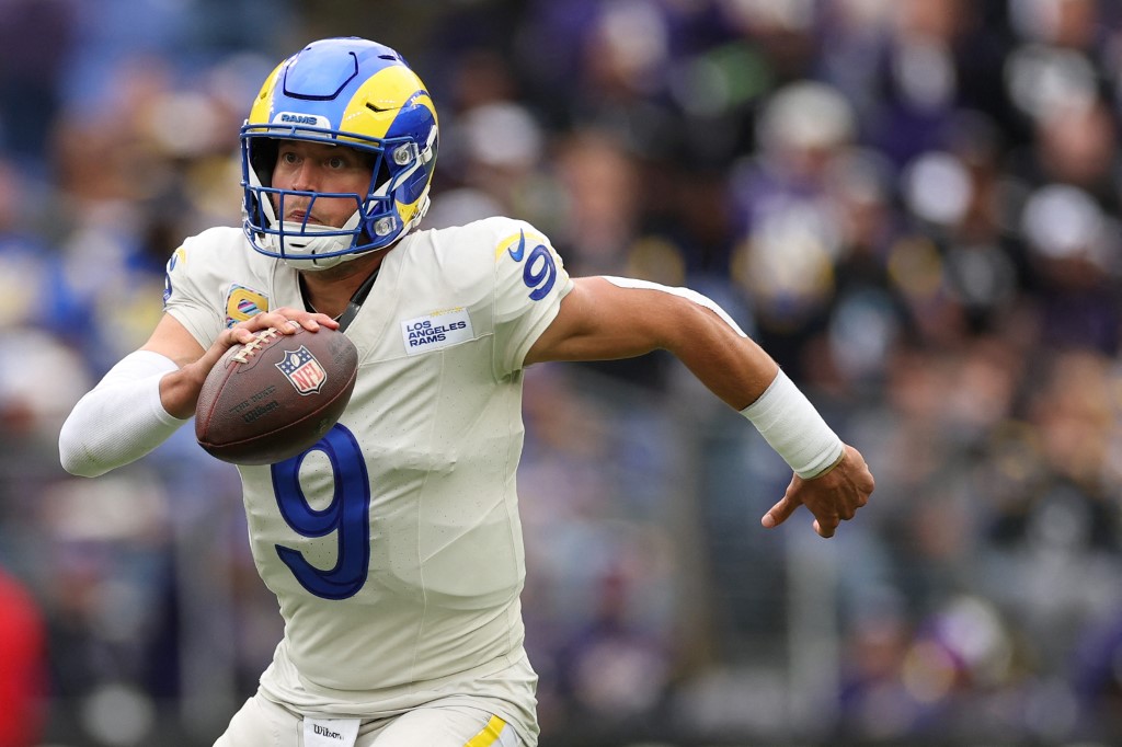 The cover for this NFL MVP odds article shows quarterback Matthew Stafford #9 of the Los Angeles Rams rushing with the the ball against the Baltimore Ravens