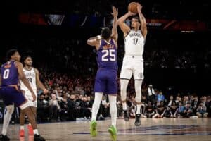 The Brooklyn Nets' Michaerl Porter Jr. #17 (R) shoots during the NBA pre-season basketball game between the Phoenix Suns and the Brooklyn Nets