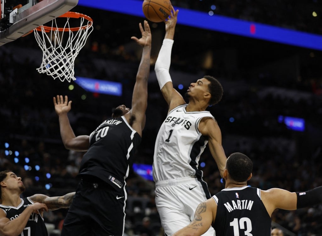 Victor Wembanyama #1 of the San Antonio Spurs goes over Day'Ron Sharpe #20 of the Brooklyn Nets