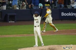 Abner Uribe #45 of the Milwaukee Brewers celebrates the final out to win game five of the National League Division Series against the Chicago Cubs.