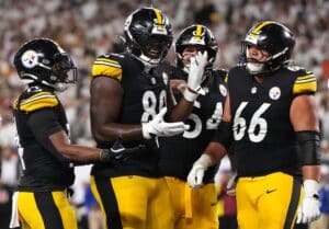 Darnell Washington #80 of the Pittsburgh Steelers celebrates with teammates after scoring a 2 yard touchdown against the Cincinnati Bengals.