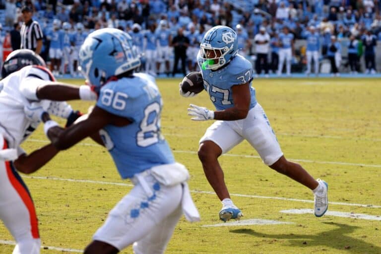 Davion Gause #37 of the North Carolina Tar Heels runs after his catch for a nine-yard touchdown in overtime against the Virginia Cavaliers.