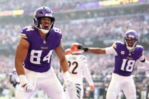 Josh Oliver #84 of the Minnesota Vikings celebrates after scoring a touchdown against the Cincinnati Bengals.