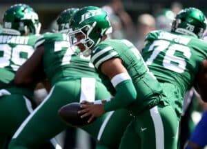 Justin Fields #7 of the New York Jets looks to hand off the ball in a game against the Buffalo Bills.