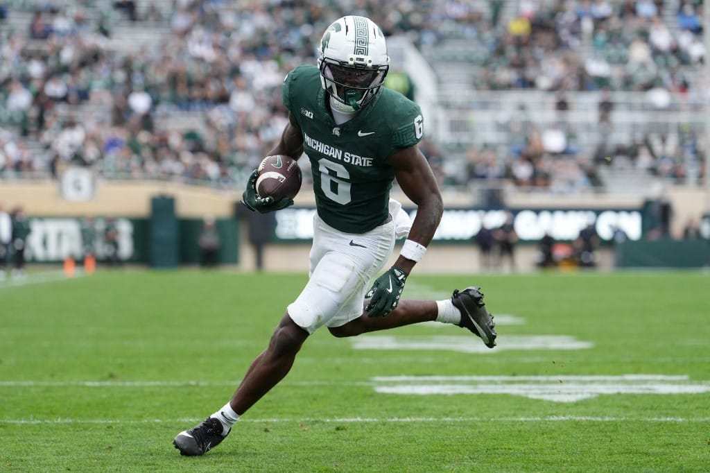 Nick Marsh #6 of the Michigan State Spartans rushes for a touchdown against the UCLA Bruins.